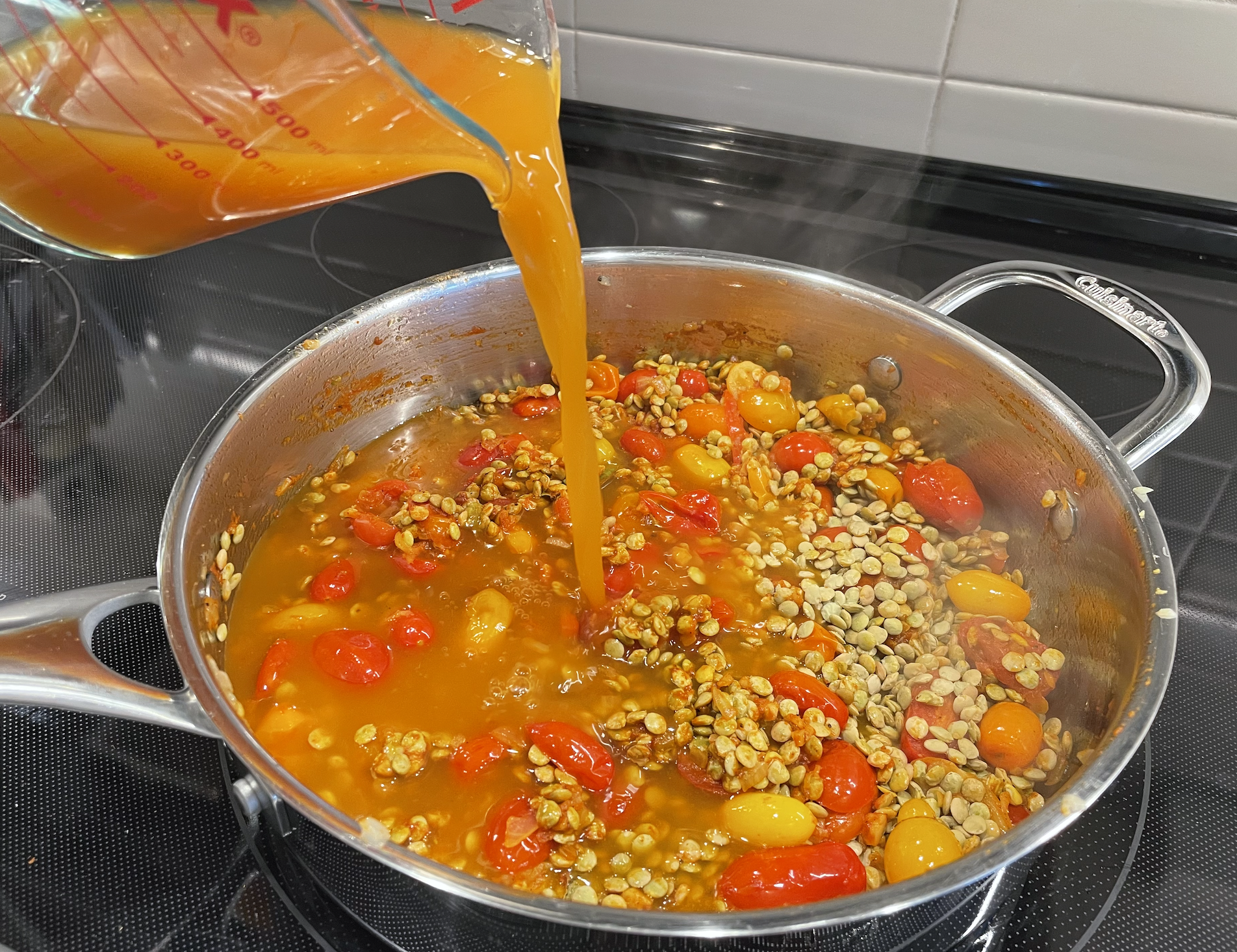 adding broth to plant-based lentil pasta