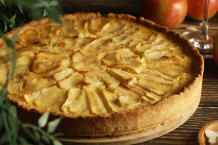 French Normandy apple cake, freshly baked on a table.